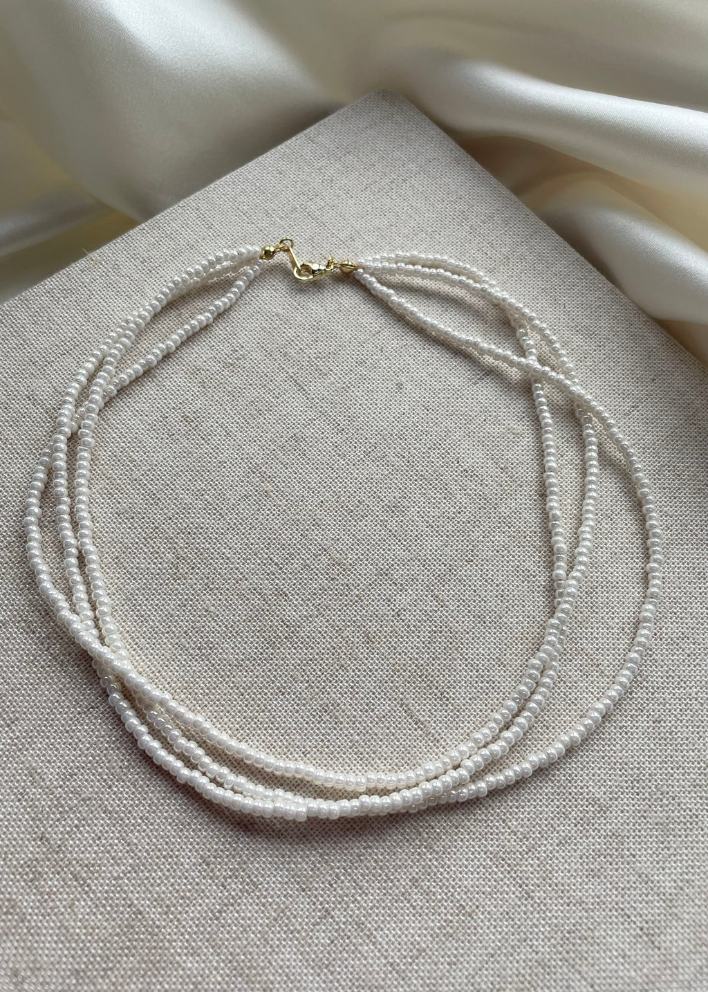 LUCIE | tiny triple strand beaded necklace